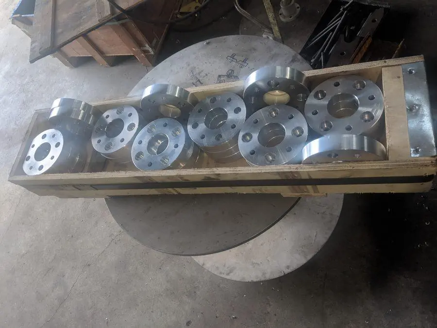 Finished machined aluminium flange plates on the bench