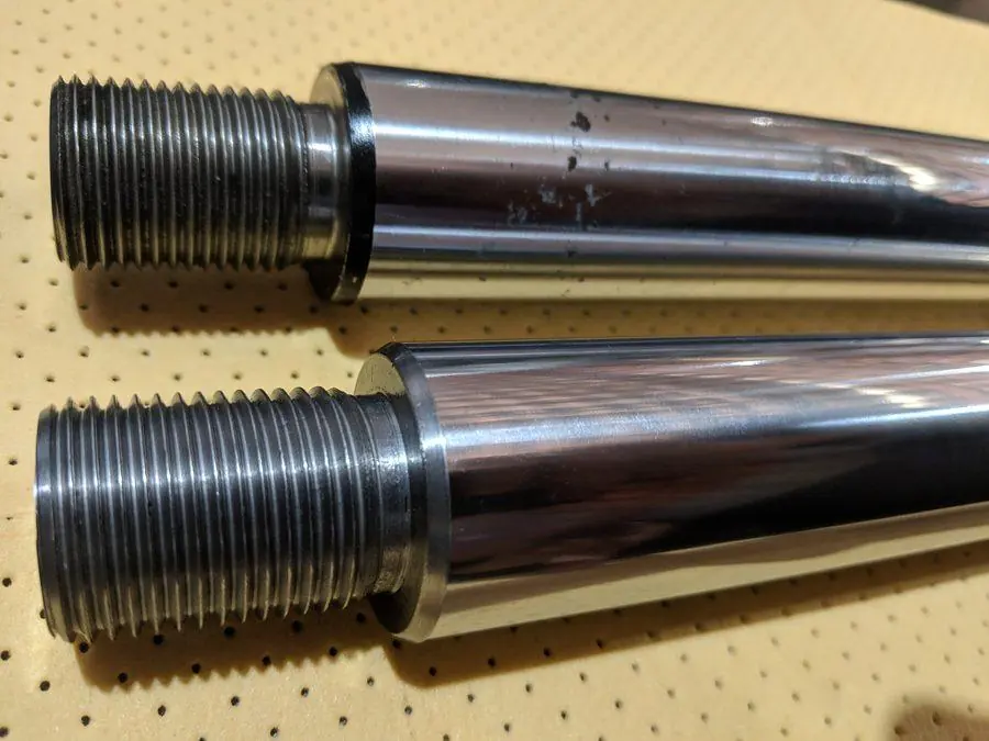Two large stainless shafts machined and threaded to size