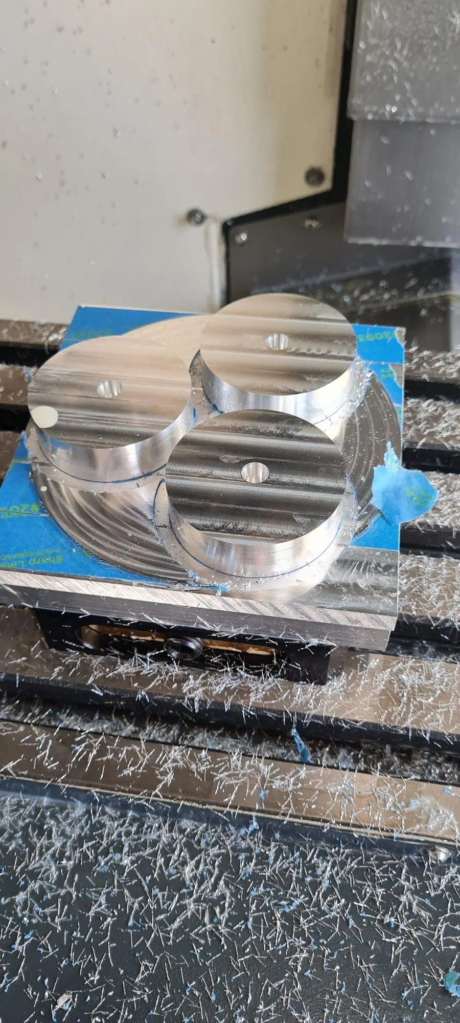 An aluminium part clamped in the vice ready for the next operation