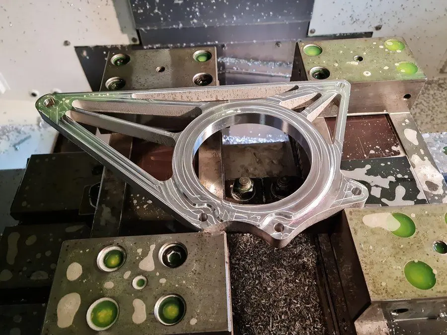 An aluminium arm set up on the mill for machining
