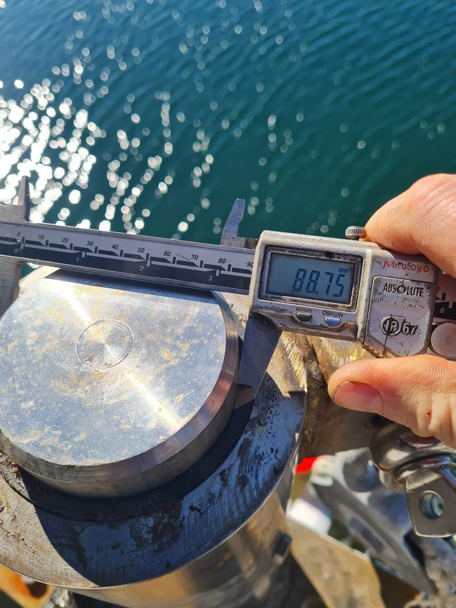 Measuring a machined part with digital calipers
