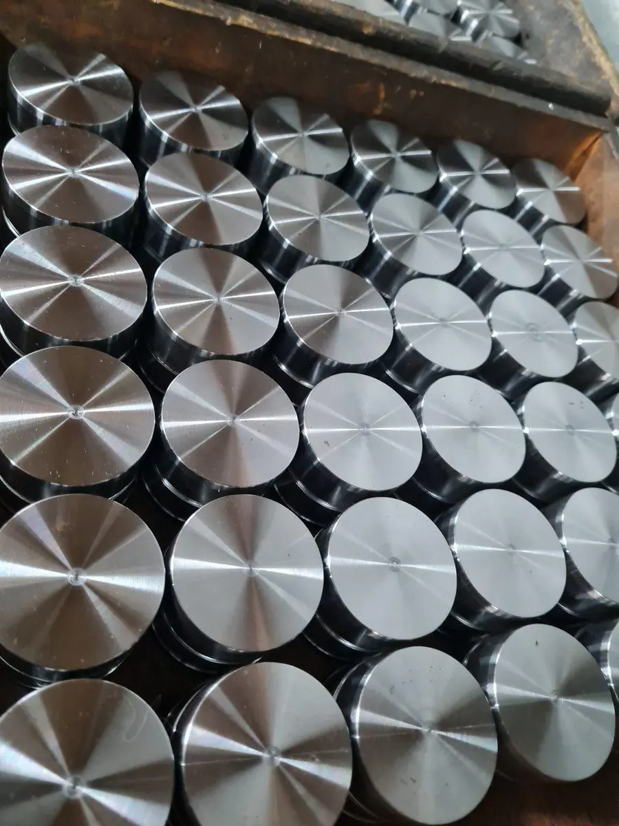A batch of identical turned steel discs from a production run