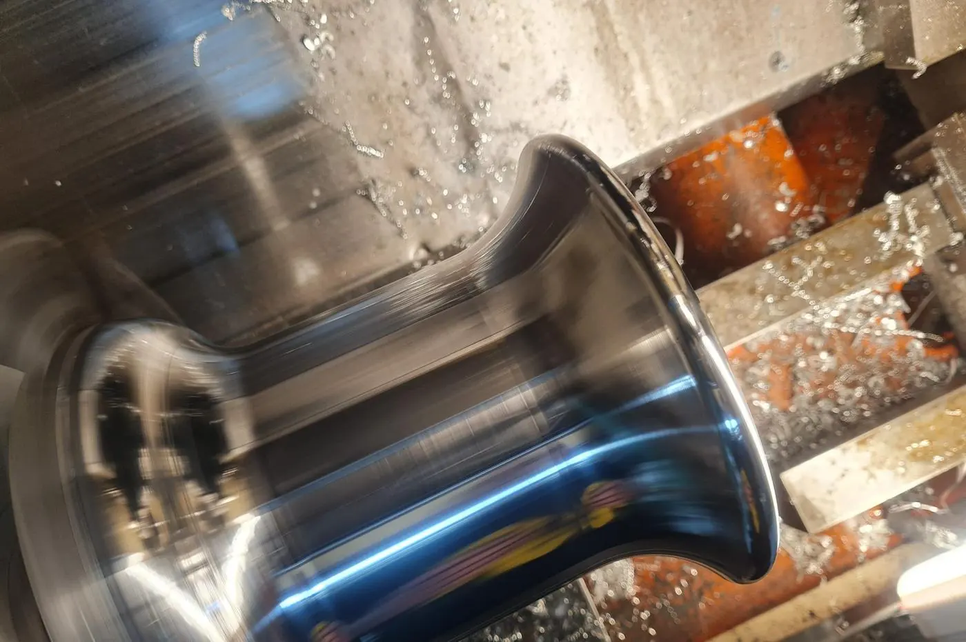 A stainless part being turned on the lathe