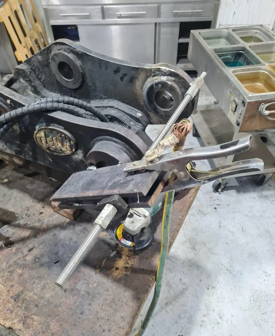 A worn excavator attachment in for repair