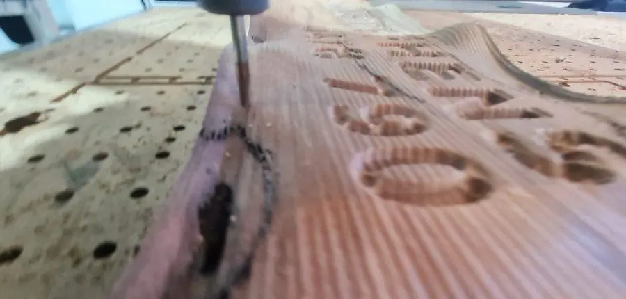 Lettering being carved into hardwood